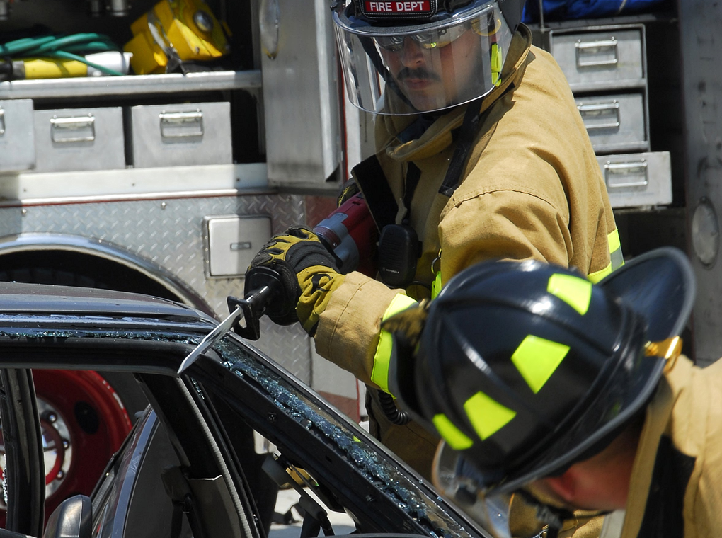 emergency service workers removing vehicle door