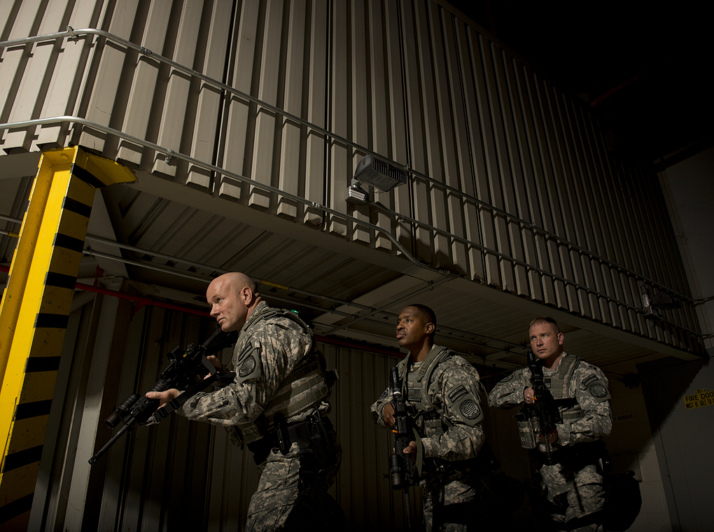 soldiers in dark, industrial setting