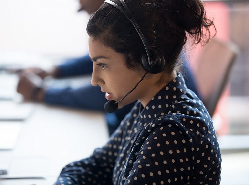 female call center worker wearing microphone headset