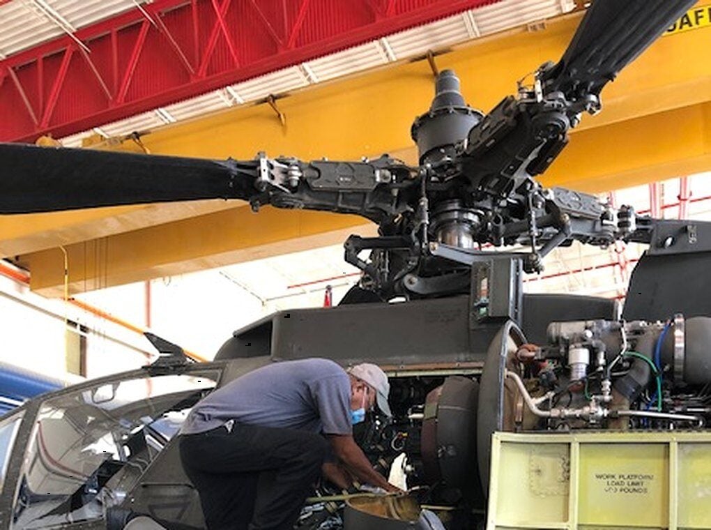 worker repairing military helicopter