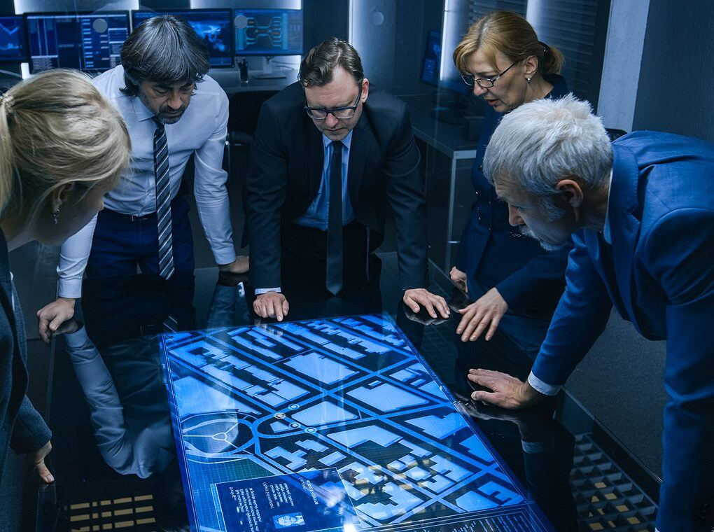 intelligence staff gathered around digital map