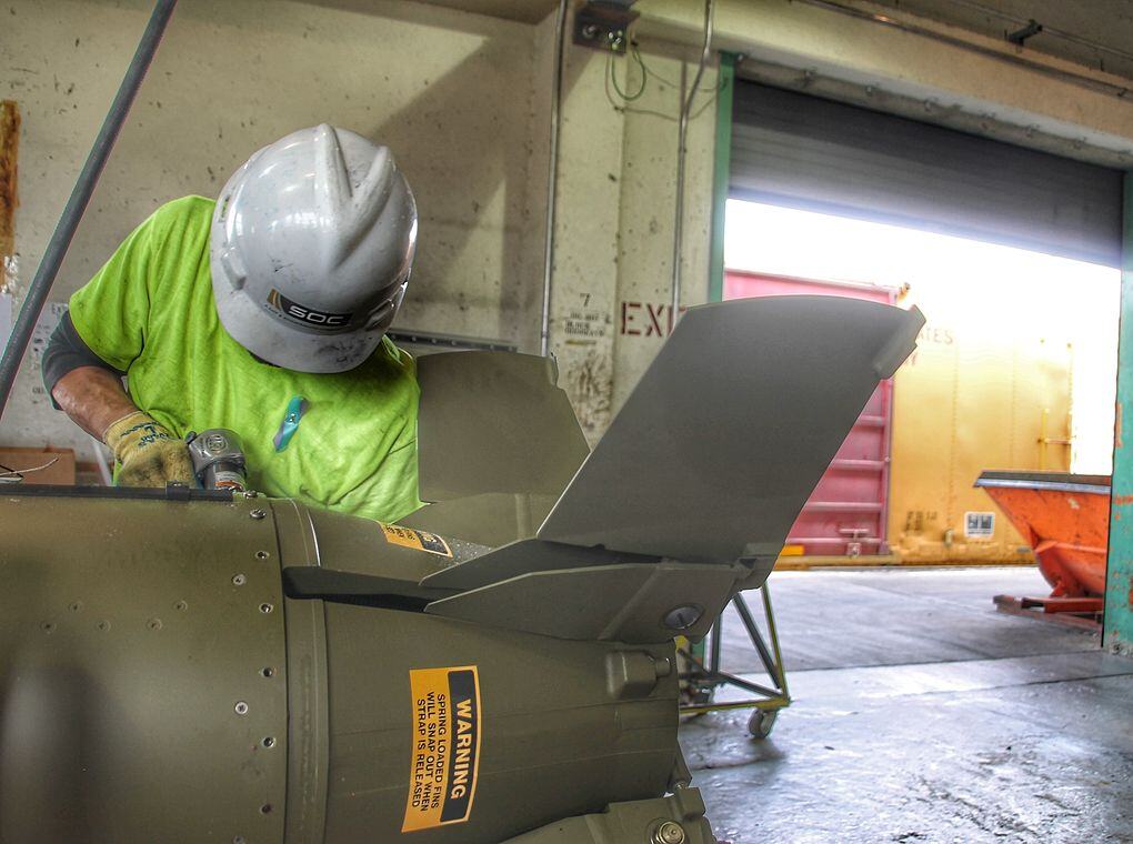 munitions factory worker performing maintenance