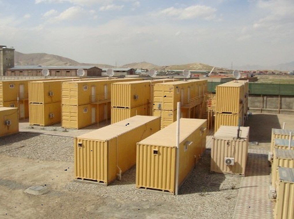 yellow, metal cargo containers in an outdoor yard