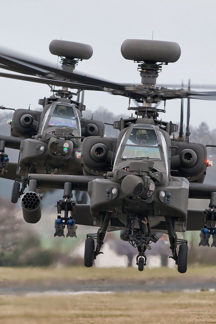 2 apache helicopters in flight
